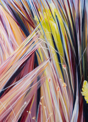 colourful long grass moving in the wind with large white cloud over head