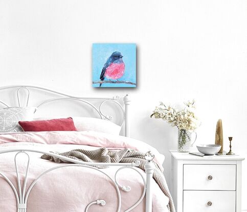 Textured oil painting of a native Australian bird, the Rose Robin, perched on a twig. The bird has a grey head and back feathers and a rose pink feathered chest. The background is sky blue.