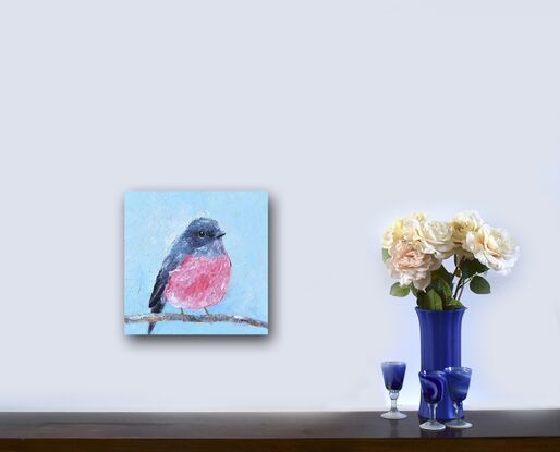 Textured oil painting of a native Australian bird, the Rose Robin, perched on a twig. The bird has a grey head and back feathers and a rose pink feathered chest. The background is sky blue.