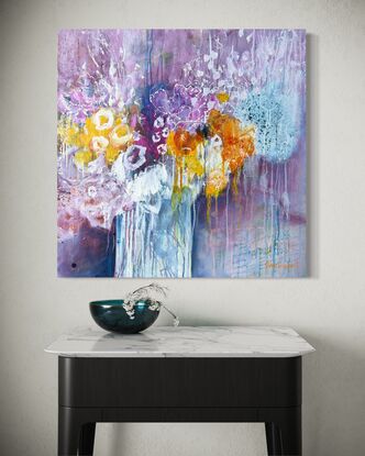 This piece is an abstract expression of a transparent vase of a generous arrangement of flowers in bright yellows, orange, pink, which and turquoise with a subtle pink background with lots of scribbles, marks and drips. 