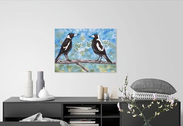 Two magpies sitting on a tree branch.