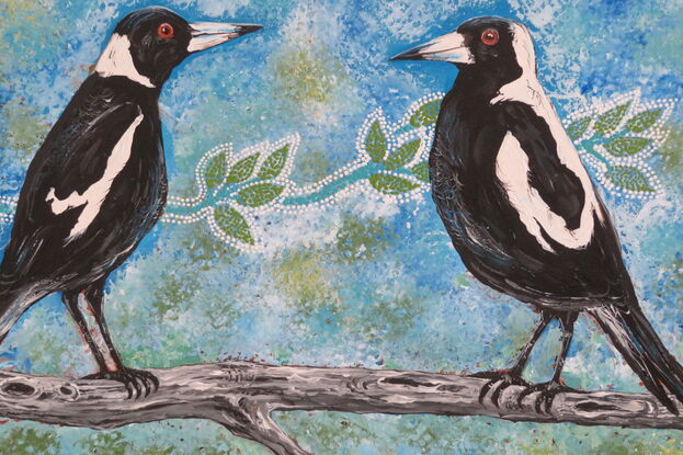 Two magpies sitting on a tree branch.