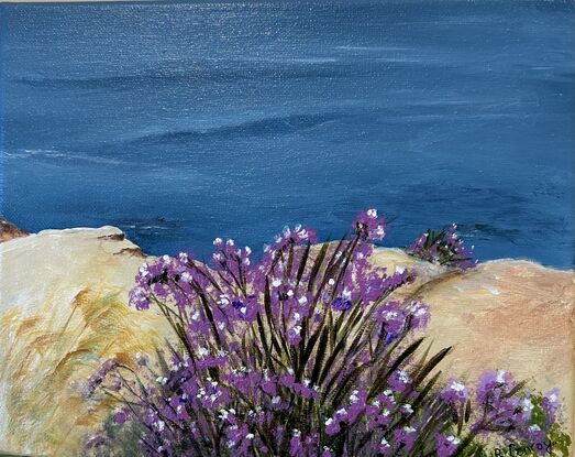 High rock ledge with flowers looking out to sea. 