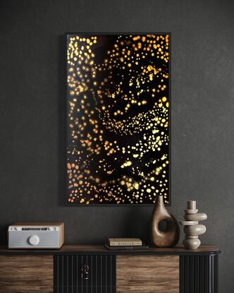 A black canvass with clusters of shimmering gold stars in an abstract impressionist style