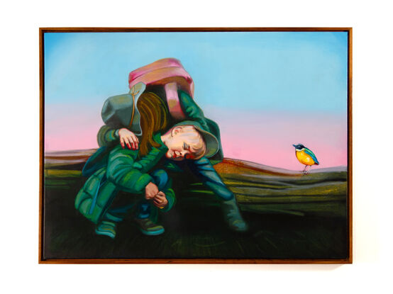 
This artwork by Tom Gibbs features two children engaged in an intimate, tender moment against a vast, open landscape. One child, wearing a green coat and hat, bends down with their head resting on the knee of the other child, who stands protectively above, partially obscured by a large, pink bag. The soft pastel hues of the sunset in the background transition from pink to blue, creating a serene and tranquil atmosphere. On the right side of the painting, a small, brightly coloured Pitta bird with yellow and green plumage stands on the ground, observing the children. The painting evokes themes of friendship, protection, and the beauty of simple, heartfelt connections amidst the expansive natural world.