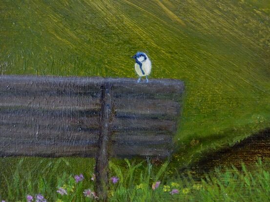 A Bird alone on a Hill sitting on a bench
