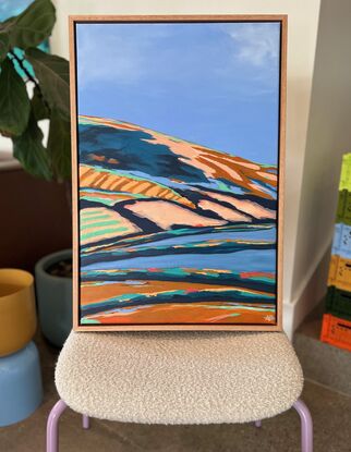 An abstract landscape painting of a rural Australian scene with strong colour, shapes and lines.  Blue sky and earthy tones throughout.  