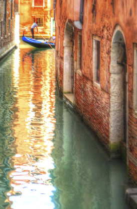 Red boat on canal in Venice, Italy