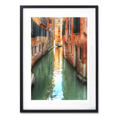 Red boat on canal in Venice, Italy