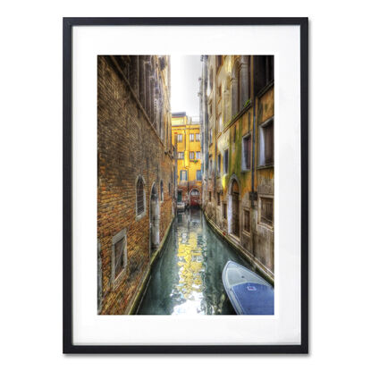 Red boat on canal in Venice, Italy