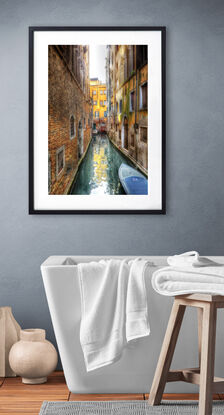 Red boat on canal in Venice, Italy