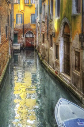 Red boat on canal in Venice, Italy