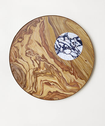 round wooden pattern with a white marble circle inside of it