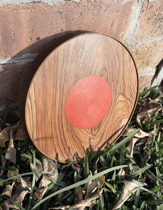 wooden circle with red small circle in the middle