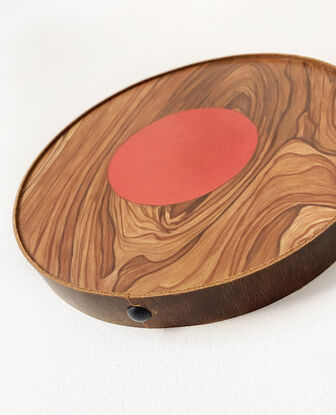 wooden circle with red small circle in the middle