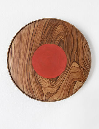 wooden circle with red small circle in the middle