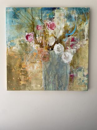 A background of golds and subtle orange and also mid blue over a dark blue base, this depicts a vase of flowers in soft tones with the strongest colour being red. A messy, elegant piece. 