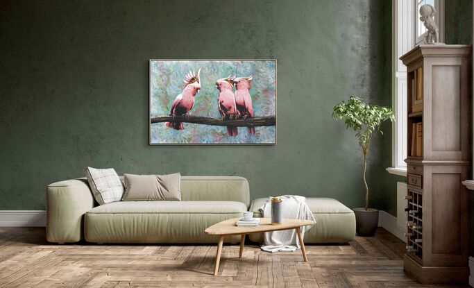 three pink cockatoos sit on a branch with abstract foliage in the background