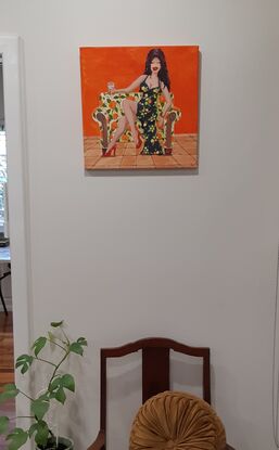 Woman drinking wine sitting on decorated couch