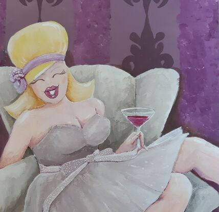 Woman drinking a Cosmopolitan while lounging on chaise lounge