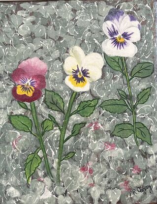 Three pansies in a garden. 