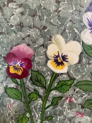 Three pansies in a garden. 