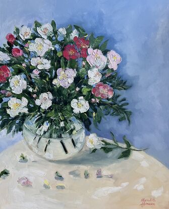 Pink and white Camellias in glass vase.