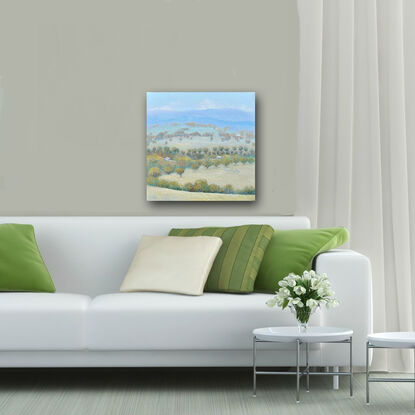 A painting of an Australian country landscape with distant rolling hills, gum trees, farm houses and grazing sheep.