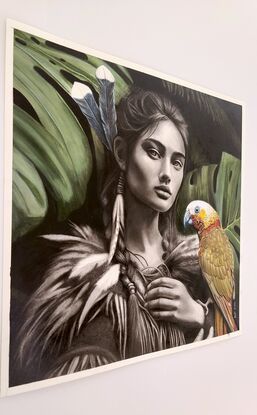 Portrait of a beautiful strong  Maori woman who is a guardian of the forest with a large parrot perched in her hands.