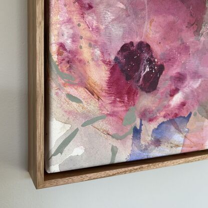 Three pink areas of colour reminiscent of flowers surrounded by light green and brown poured and dropped paint.