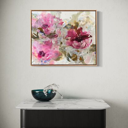 Three pink areas of colour reminiscent of flowers surrounded by light green and brown poured and dropped paint.