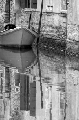 Inviting reflection on canal in Venice, Italy