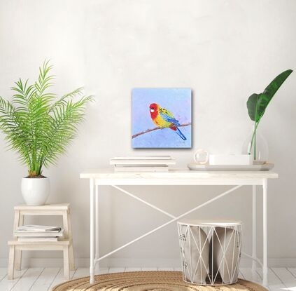 Textured oil painting of a native Australian bird, the Eastern Rosella parrot. Its face is red with a white spot on the cheek. The chest and back are bright yellow and lime green. The wings and tail feathers are blue.