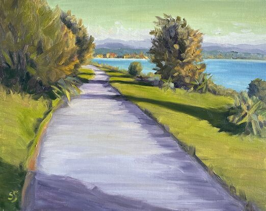 A quiet walkway beside Lake Taupo, New Zealand, during the golden hour before sunset. 