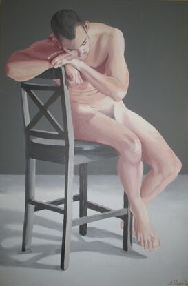 3/4 view of nude man sitting on chair, cheek resting on hands holding back of chair