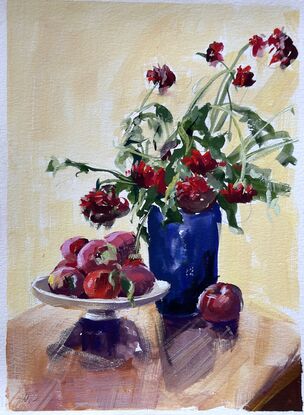 Backlit Red dahlias in a dark vase with a bowl of apples casting a shadow forward