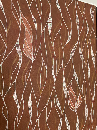 Loose patterns of white and bronze set against a background of earthy orange/red.