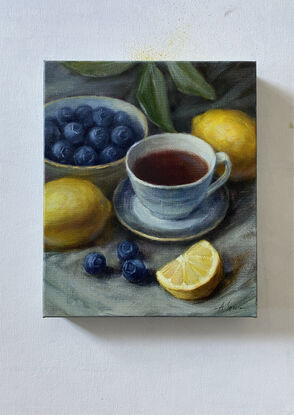 Still life with  lemons, blueberry ,  a cup of tea/coffee 