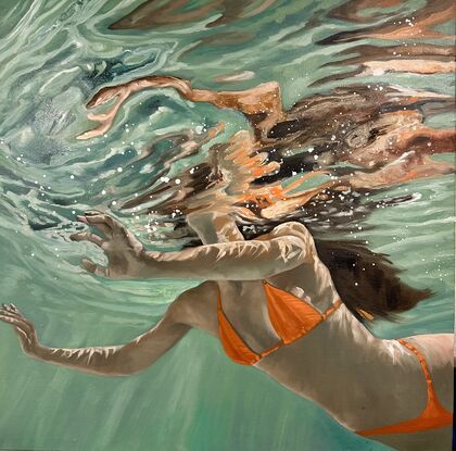 Woman with an orange bikini swimming in green water with long dark hair, reflections, bubbles and light accents.