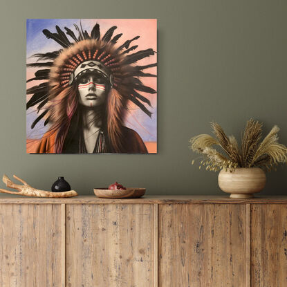 Portrait of a beautiful American Indian woman with a feathered headdress against a pink and blue sunset sky.