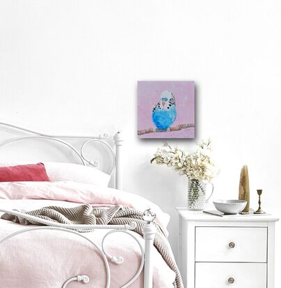 A thickly textured oil painting of a colourful budgerigar with bright blue and white feathers, perched on a  branch. The background is a soft pink, which contrasts nicely with the vibrant colour of the bird.