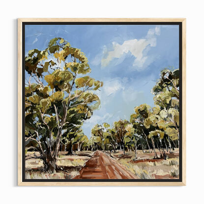 A red track is bordered by swaying gumtrees that make an archway. The blue sky is dotted with clouds. 