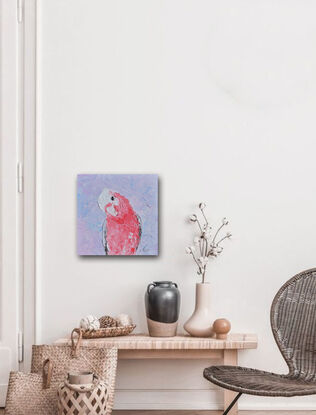 A textured portrait painting of a pink, grey and white galah cockatoo is depicted against a soft lavender background.