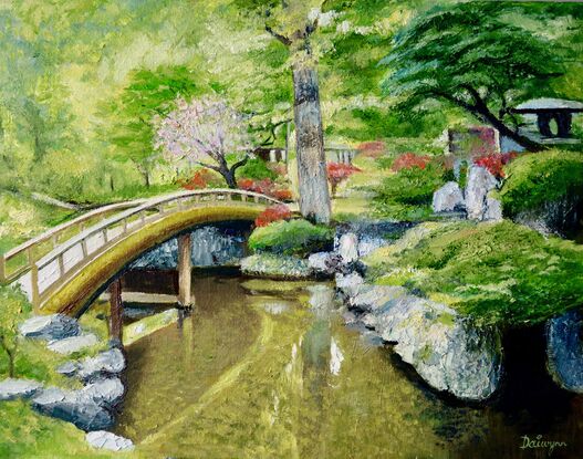 Curved bridge in a Japanese stone and water garden.