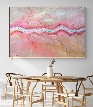 The Sweetest Stream is a colourful textured aerial landscape in pink and peach tones with vivid blue winding river dotted with tiny trees running horizontally through the landscape.