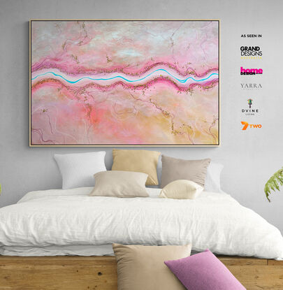 The Sweetest Stream is a colourful textured aerial landscape in pink and peach tones with vivid blue winding river dotted with tiny trees running horizontally through the landscape.