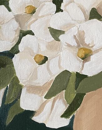 White flowers in a beige vase on a warm background.