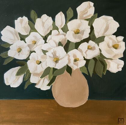 White flowers in a beige vase on a warm background.