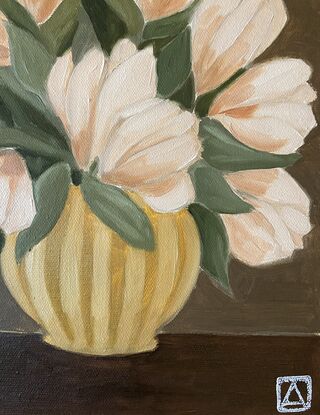 Pale pink flowers in a mustard vase on a dark background