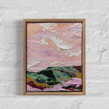 Pink skies covering lush textured landscape 